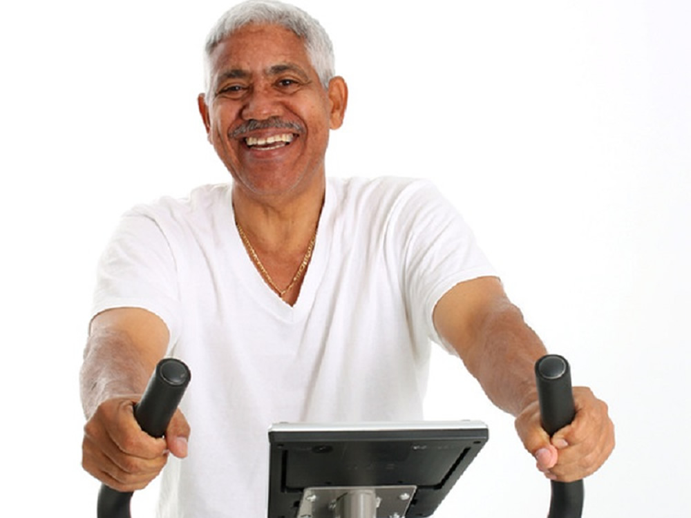 Older man on stationary bike, wondering about Social Security and Medicare benefits in the future