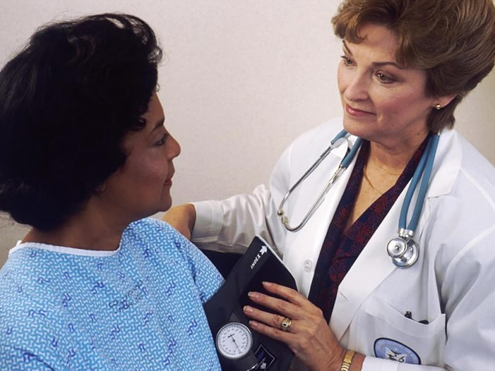 Female doctor advising her patient on the Medicare open enrollment period