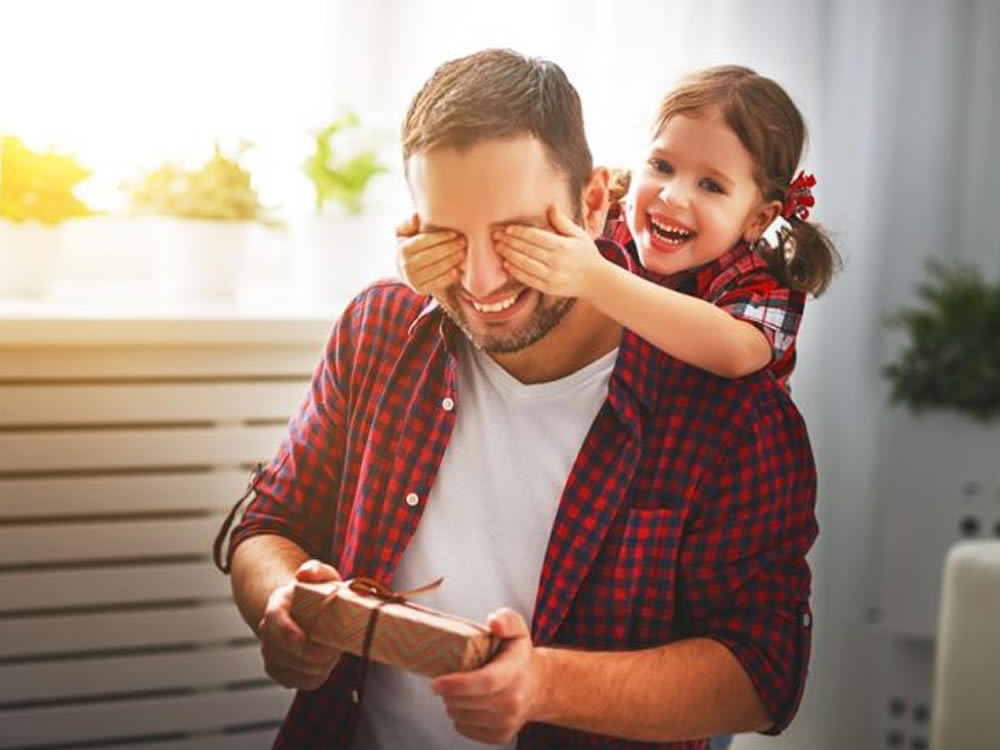 Little girl suprising her father with a unique, memorable and financially responsible holiday gift