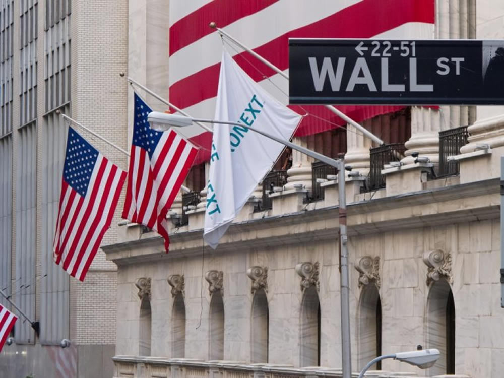 Flags flying on Wall Street with stocks at market highs