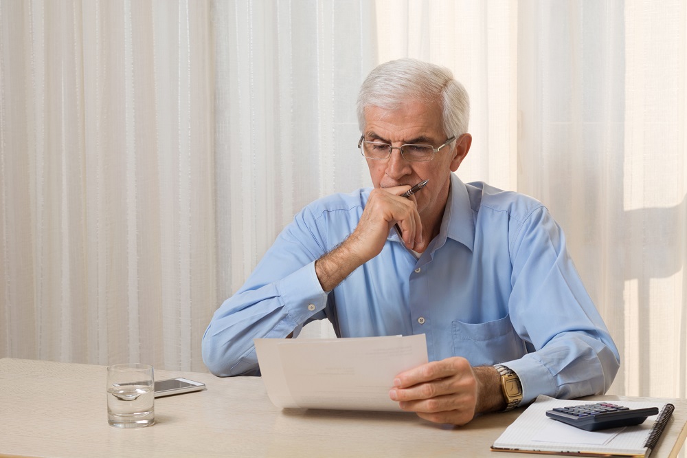 Older man considering bonds versus CDs in a rising interest rate environment
