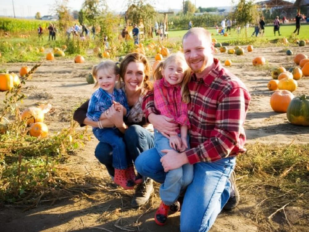 Young family in pumpkin patch are grateful for family gifting