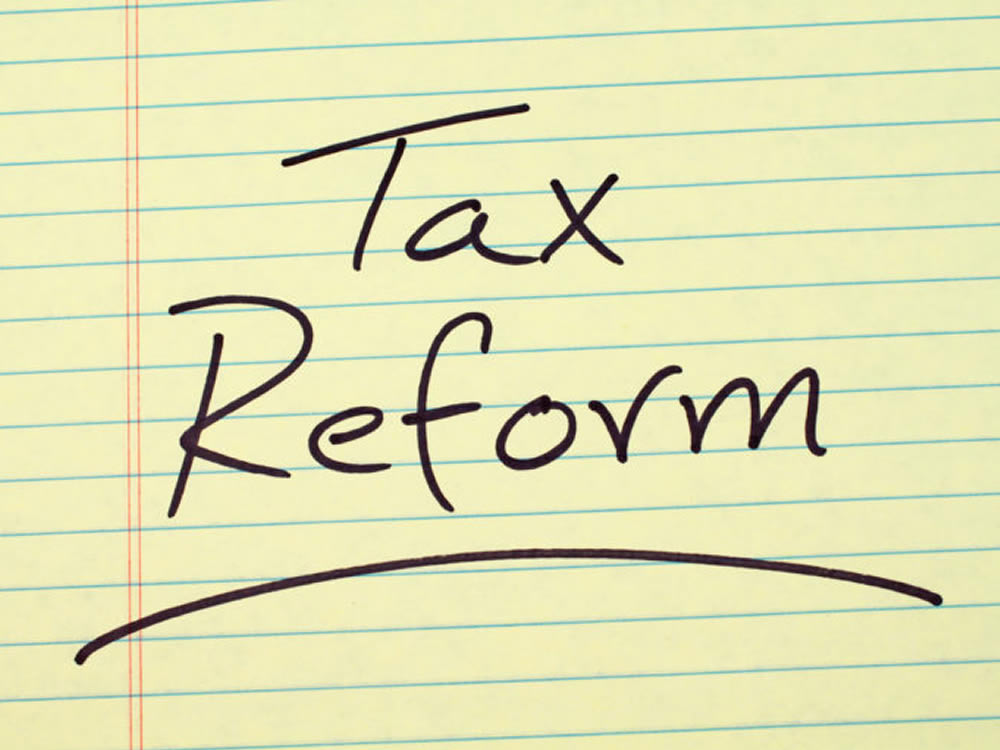 The words tax reform written on a memo pad refer to new tax laws