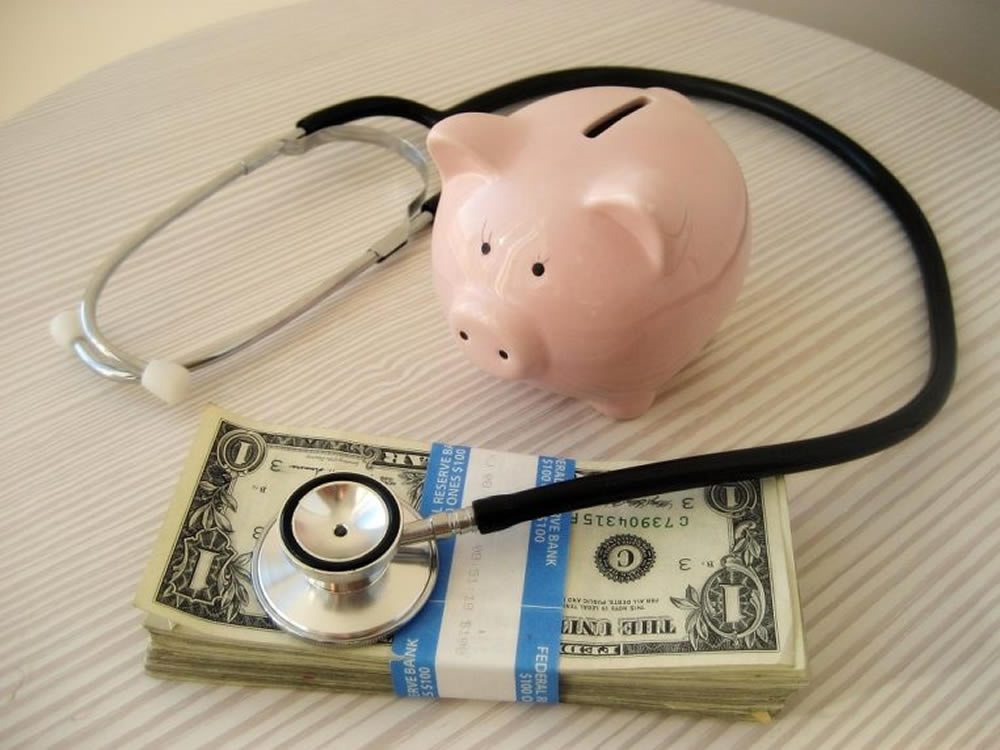 Stethoscope and piggy bank and dollar bills symbolize healthcare costs in retirement