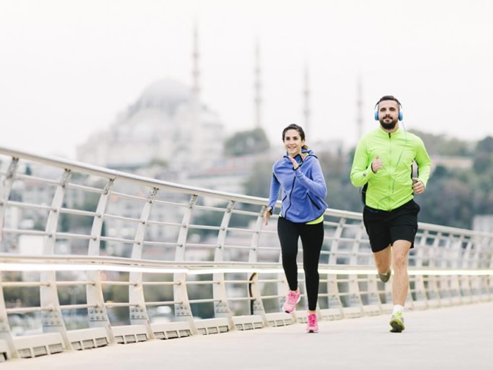 Two Millennials, running across bridge towards their financial goals