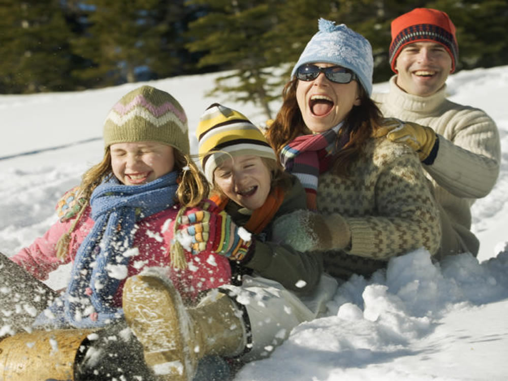 Laughing family on sled celebrate their NY financial fulfilment and freedom