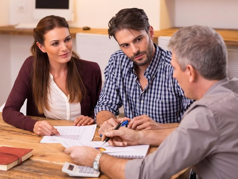 Fiduciary financial advisors talks to client couple about joint ownership