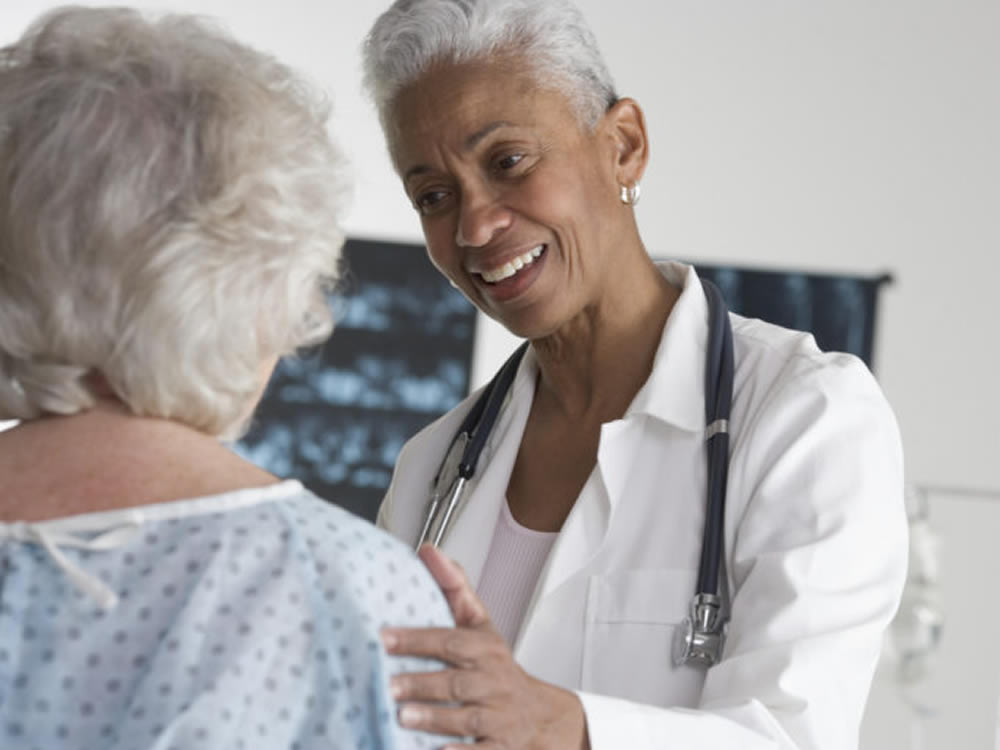 Female doctor talking to senior patient during Medicare check-up appointment