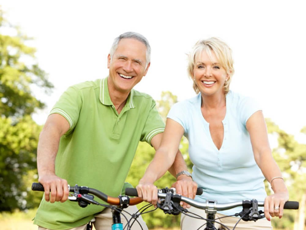 Older couple biking know to avoid these top 10 retirement myths