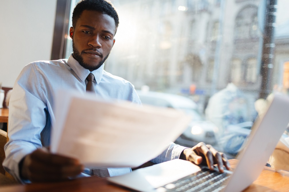 Young man considers his cash balances and current yield on cash